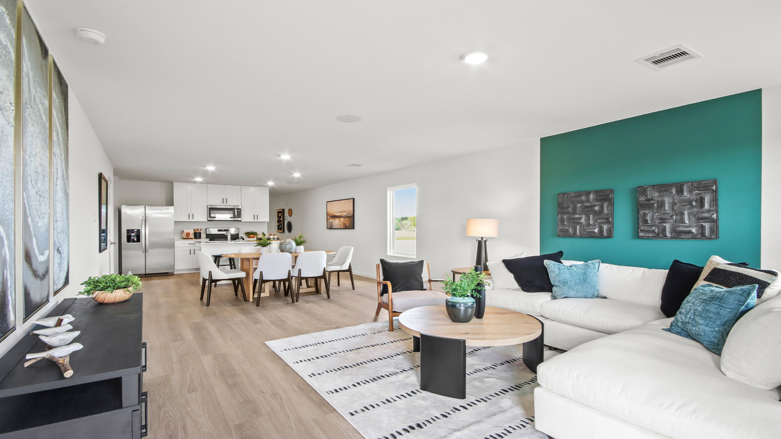 open concept livving and dining area with vinyl flooring and large windows