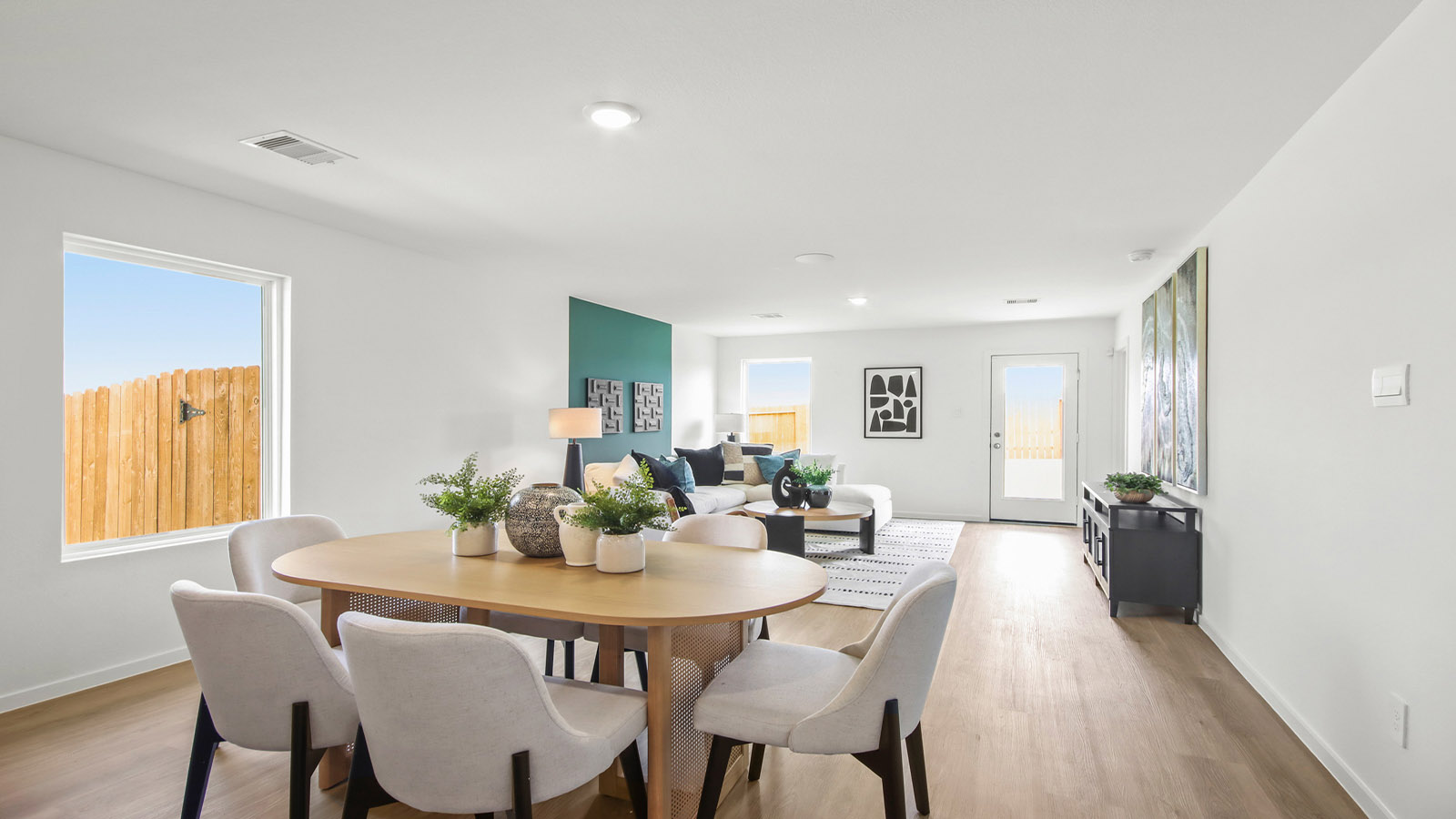 open concept livving and dining area with vinyl flooring and large windows