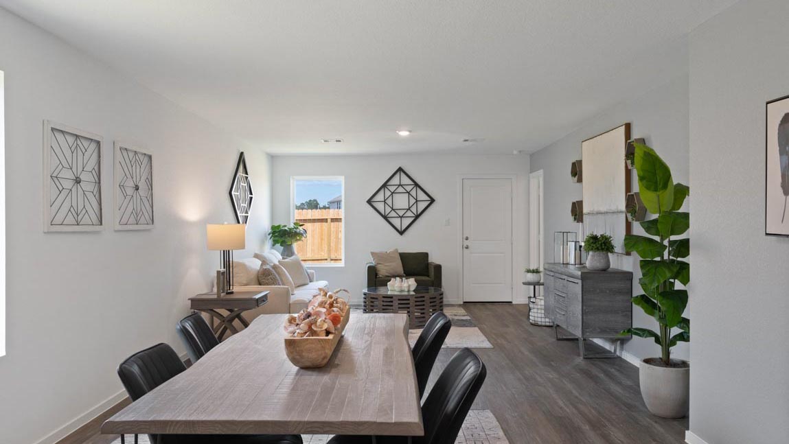open concept livivng and dining area with vinyl flooring, quartz countertops, and large windows