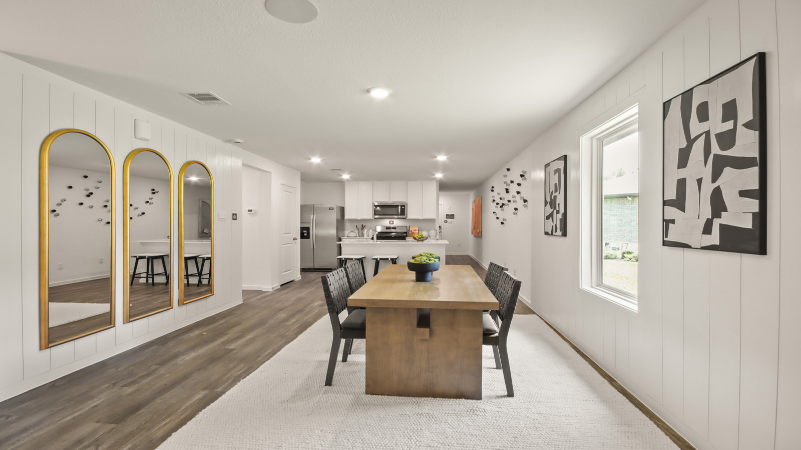 open concept living and dining with vinyl flooring