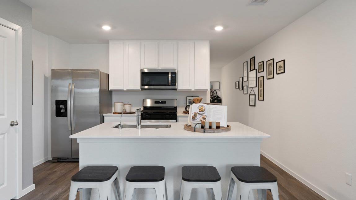 Kitchen with quartz countertops, modern hardware and an island and vinyl floor