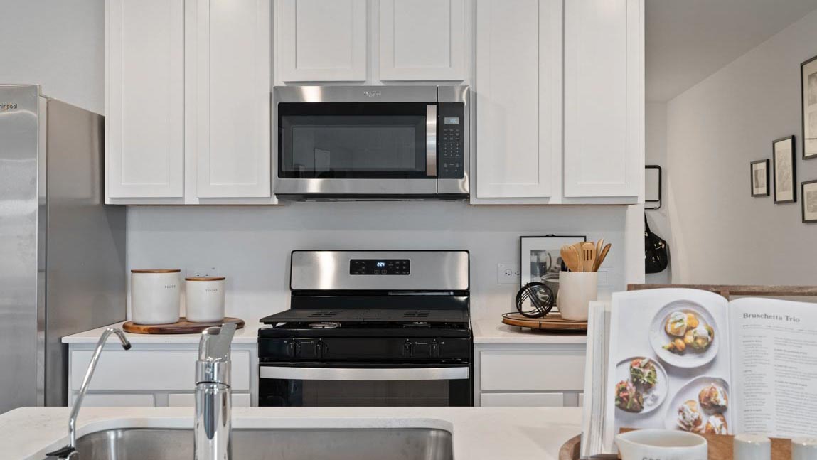 Kitchen with quartz countertops, modern hardware and an island and vinyl floor