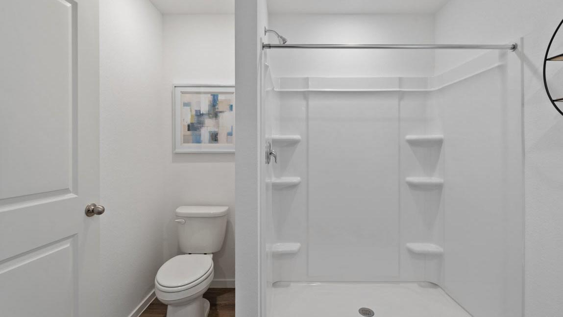 Primary bathroom with stand-alone shower with tiles and semi frameless glass in Hockley TX