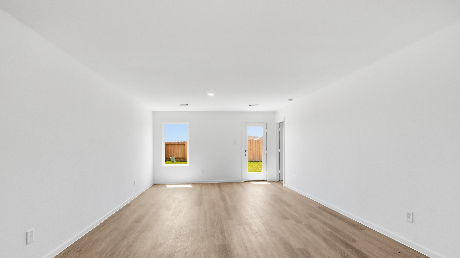 open concept living area with vinyl flooring, large windows, and quartz countertops