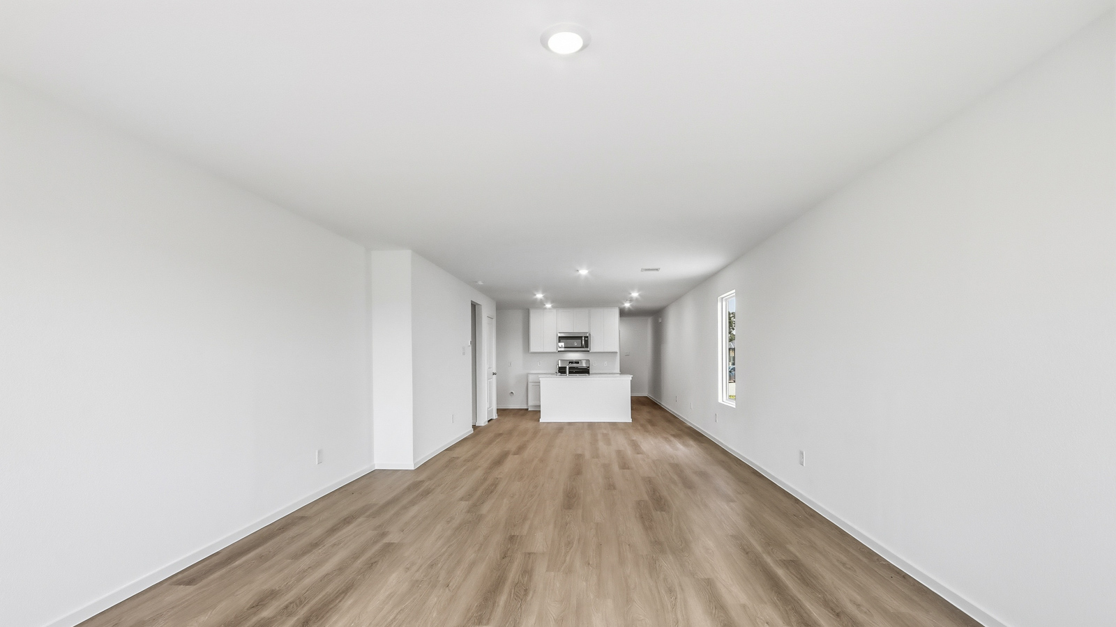 open concept living area with vinyl flooring, large windows, and quartz countertops
