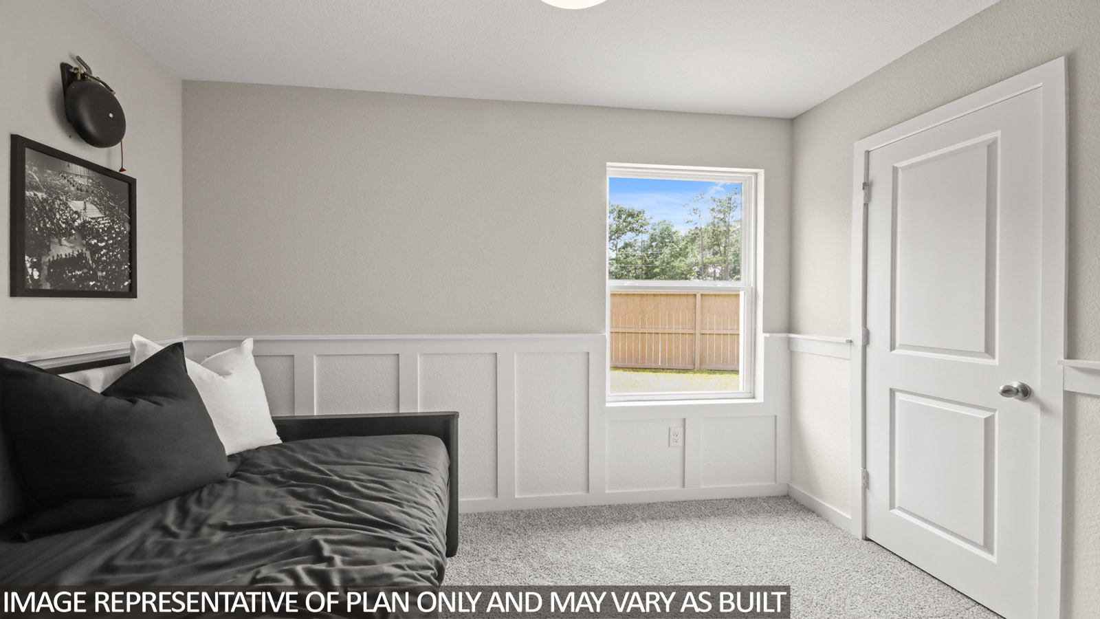 secondary bedoom with carpet flooring and window