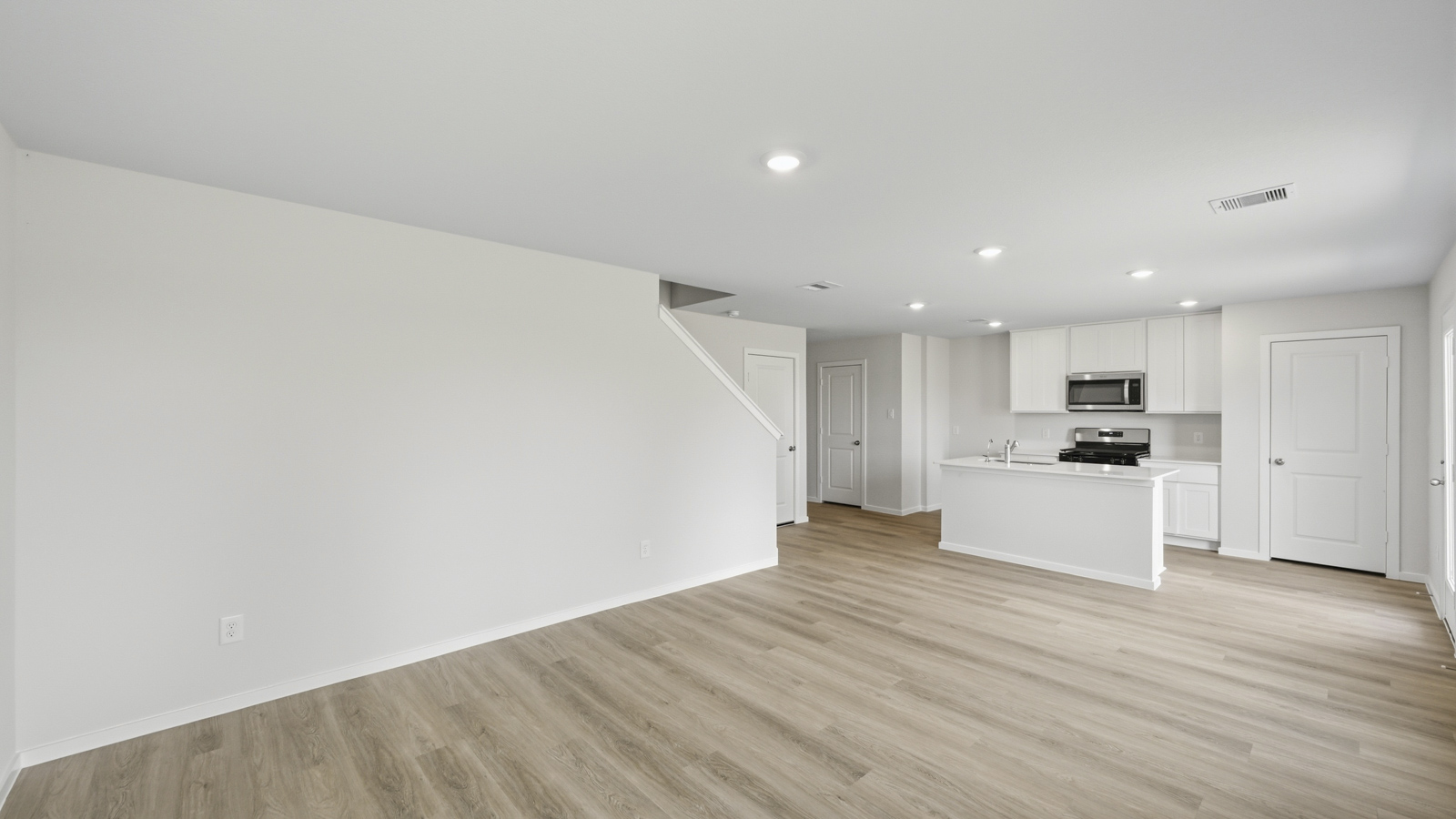 open concept living and dining area with vinyl flooring, large windows, and quartz countertops