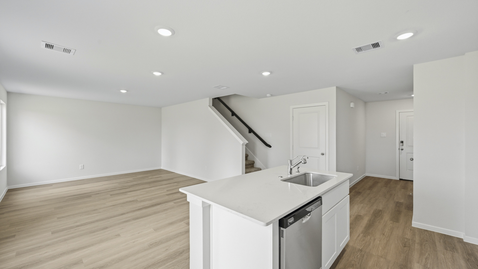 open concept living and dining area with vinyl flooring, large windows, and quartz countertops