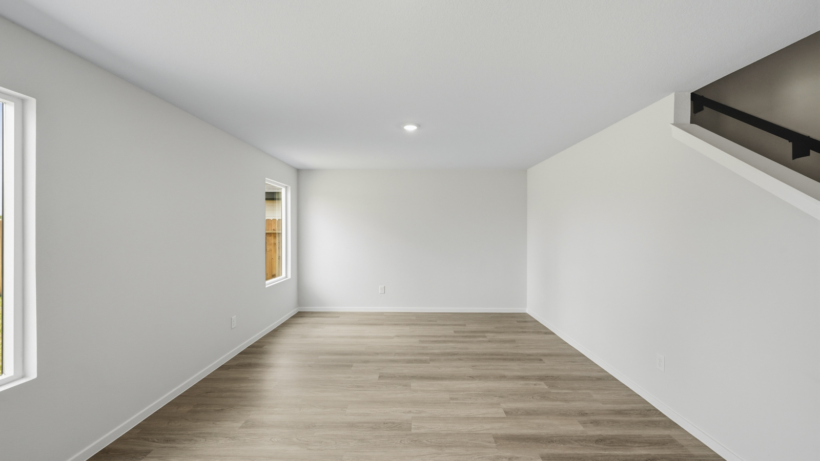 open concept living and dining area with vinyl flooring, large windows, and quartz countertops
