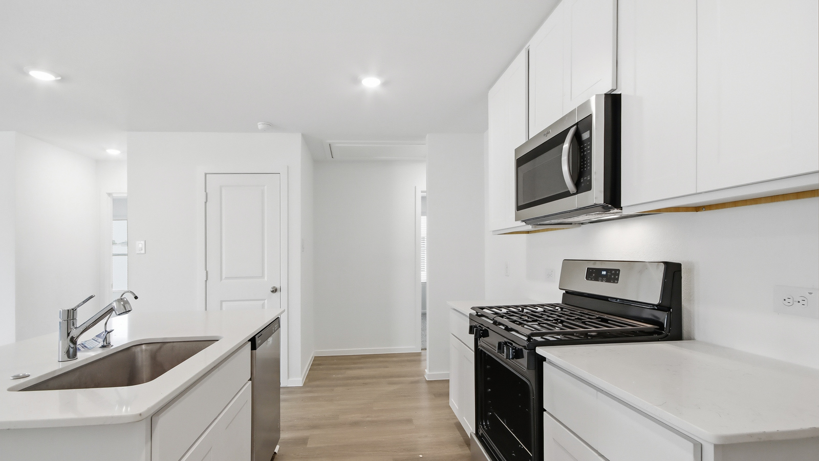 open concept living and dining area with vinyl  flooring, large windows, and quartz countertops