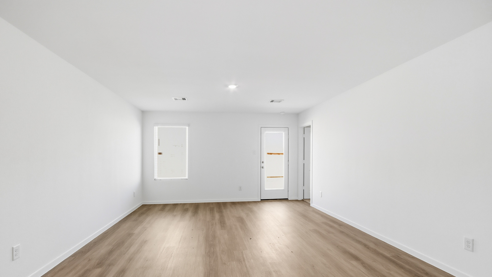 open concept living and dining area with vinyl  flooring, large windows, and quartz countertops