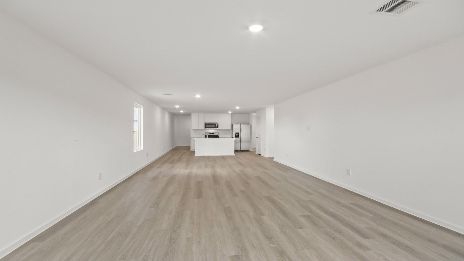 open concept living and dining area with vinyl flooring and large windows