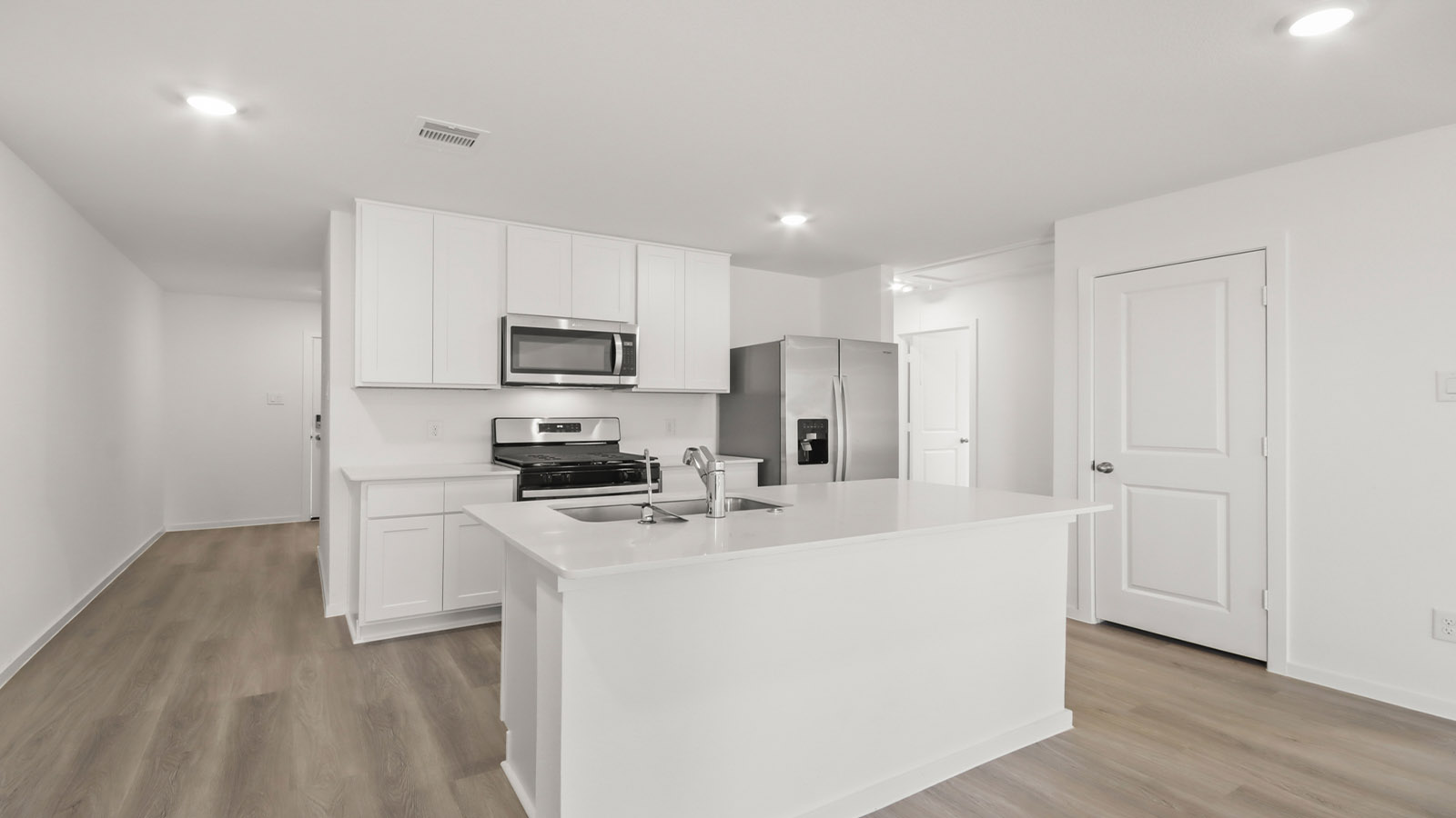 open concept living and dining area with vinyl flooring and large windows