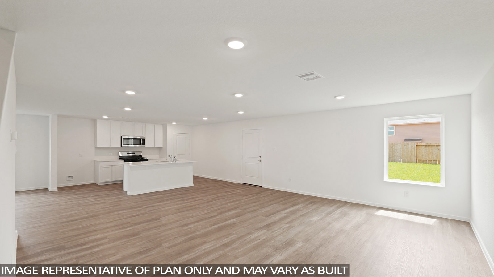 open concept living and dining area with quartz countertops, large windows, and stainless steel appliances