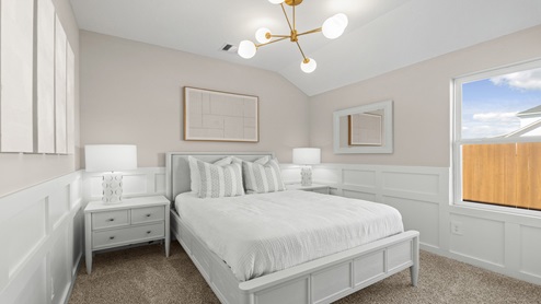 secondary bedroom with carpet and window