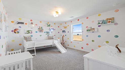 secondary bedroom with carpet and window
