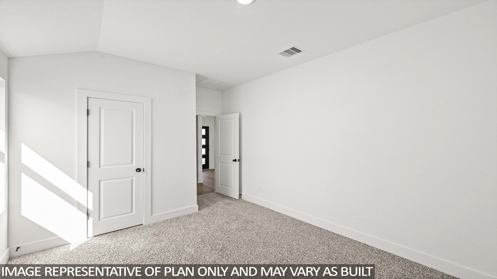 Secondary bedroom with shag carpet flooring and bright window