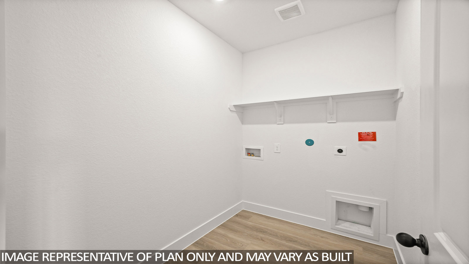 Utility room with storage located off the entry hallway and garage door