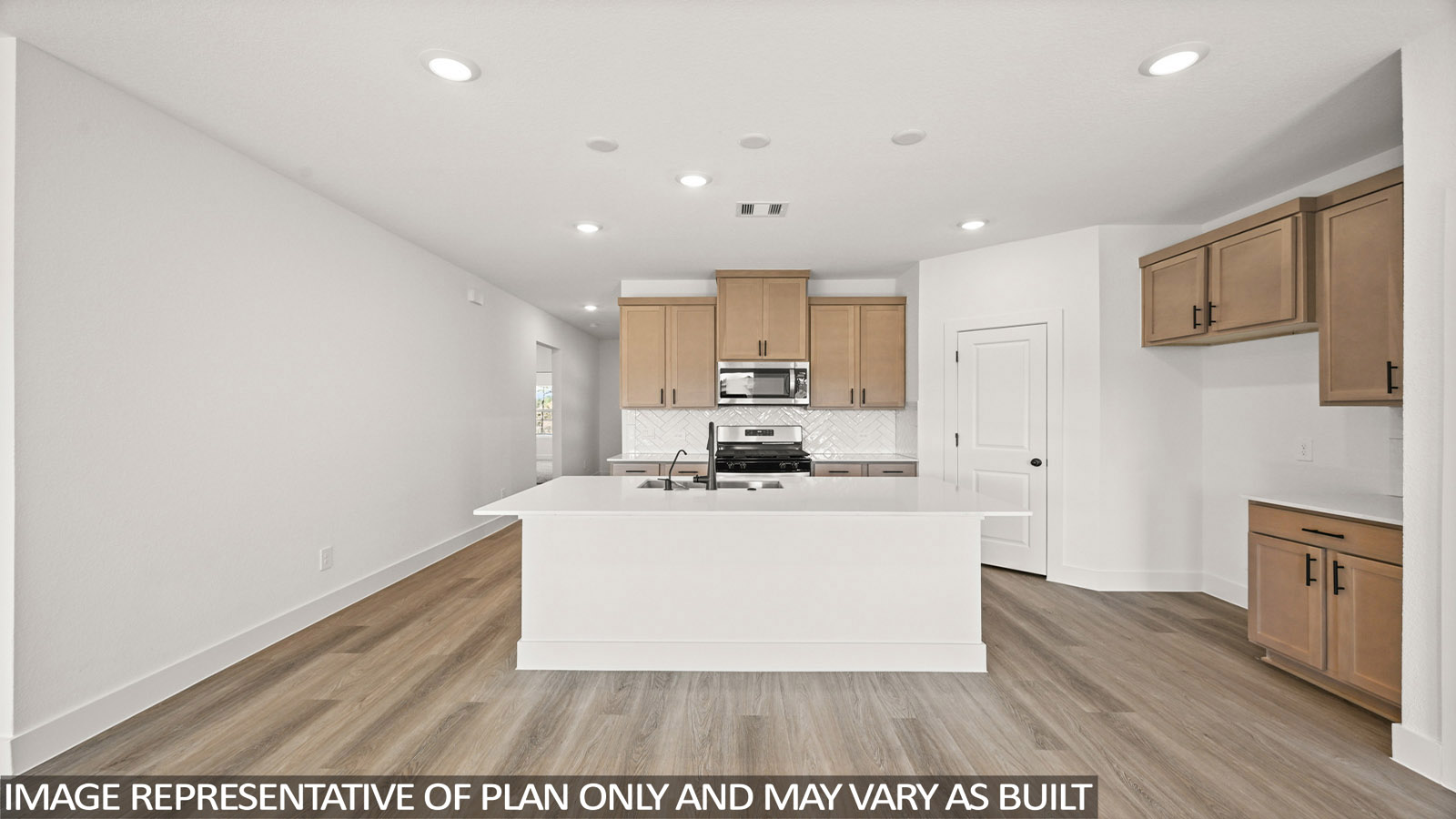 Kitchen with quartz countertops and an island and vinyl floor
