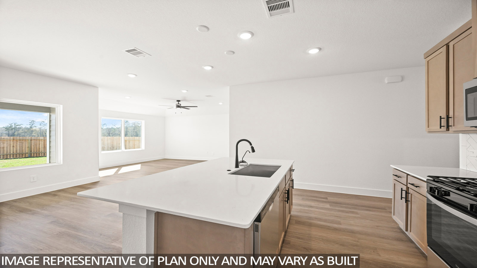 Kitchen with quartz countertops and an island and vinyl floor