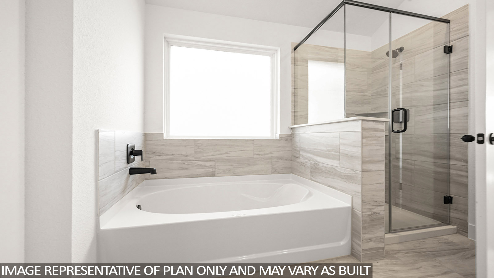 Primary bathroom with soaker tub and tile shower with semi frameless glass in Katy TX