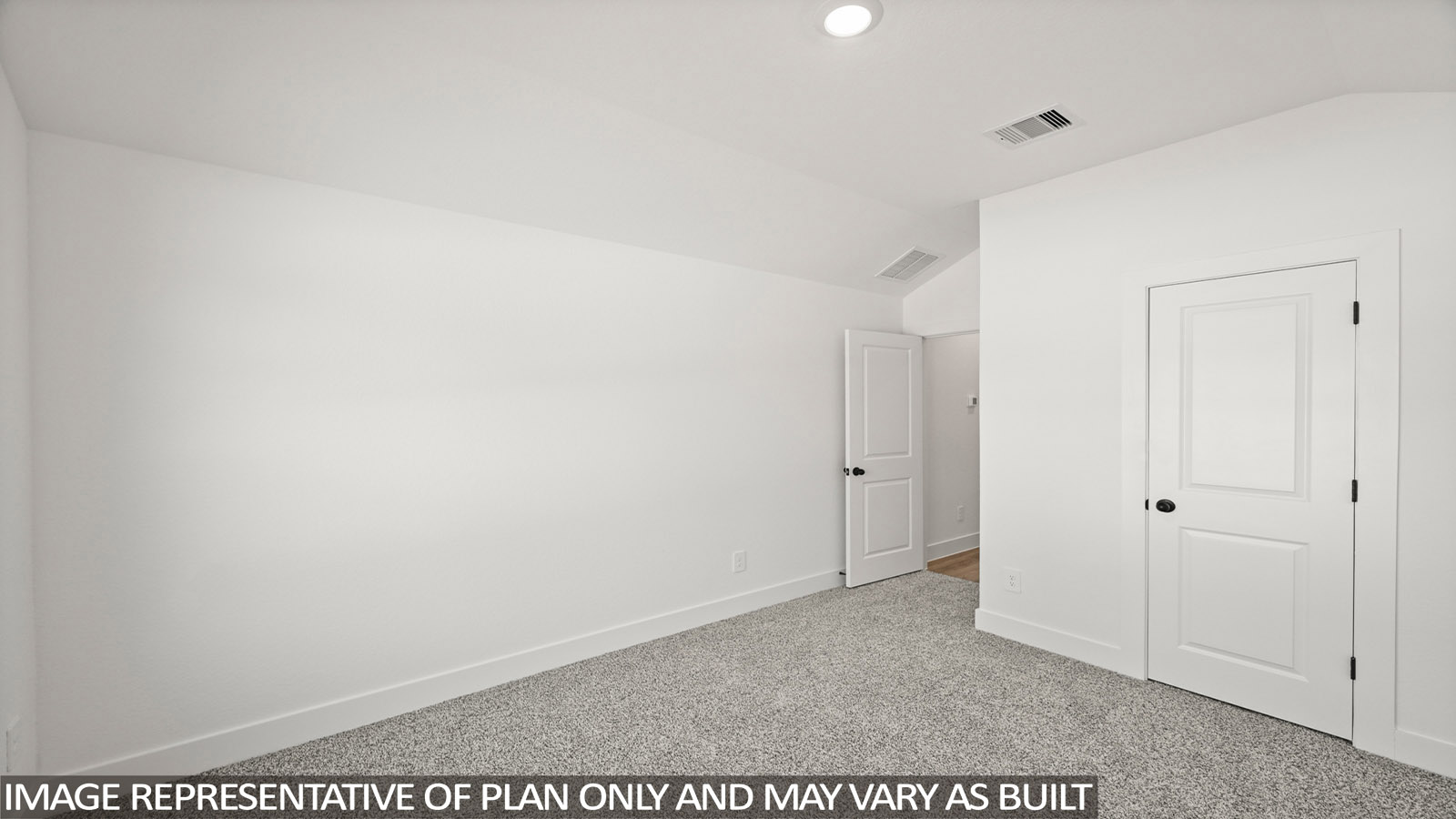 Secondary bedroom with carpet flooring