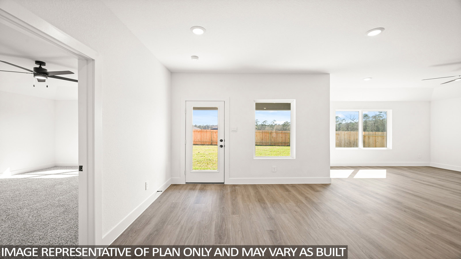 Spacious living area with vinyl flooring