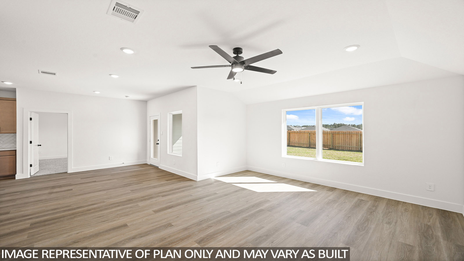 Spacious living area with vinyl flooring