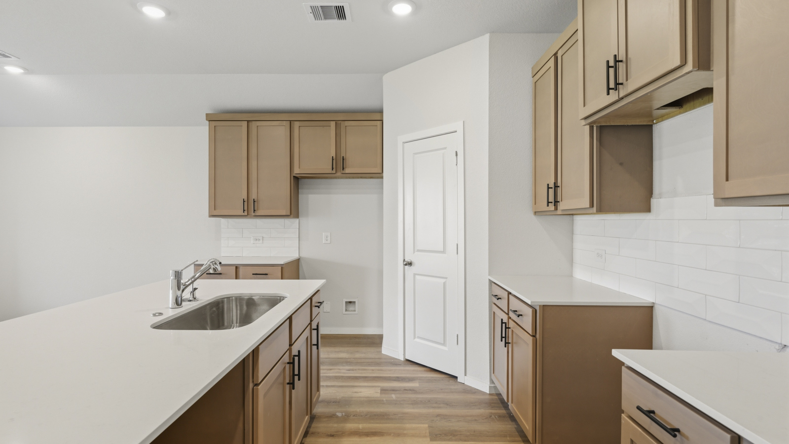 Open concept living and dining area with vinyl flooring and large windows in Brookshire, TX