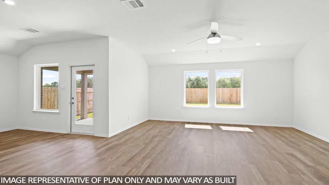 Open concept living and dining area with vinyl flooring and large windows in Brookshire, TX