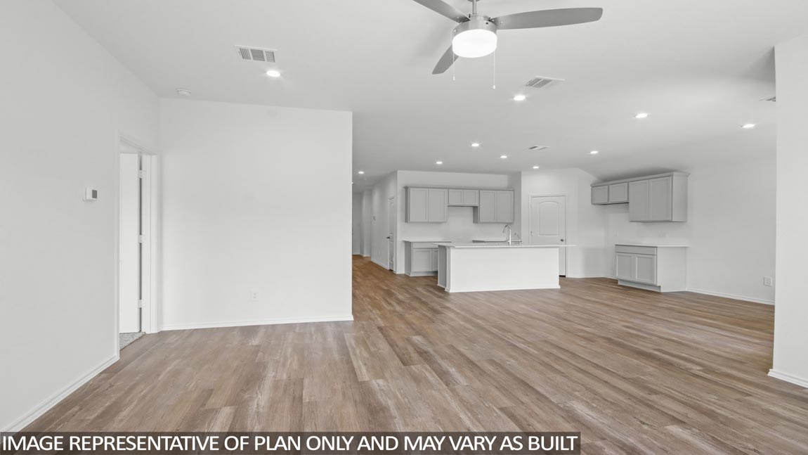Open concept living and dining area with vinyl flooring and large windows in Brookshire, TX