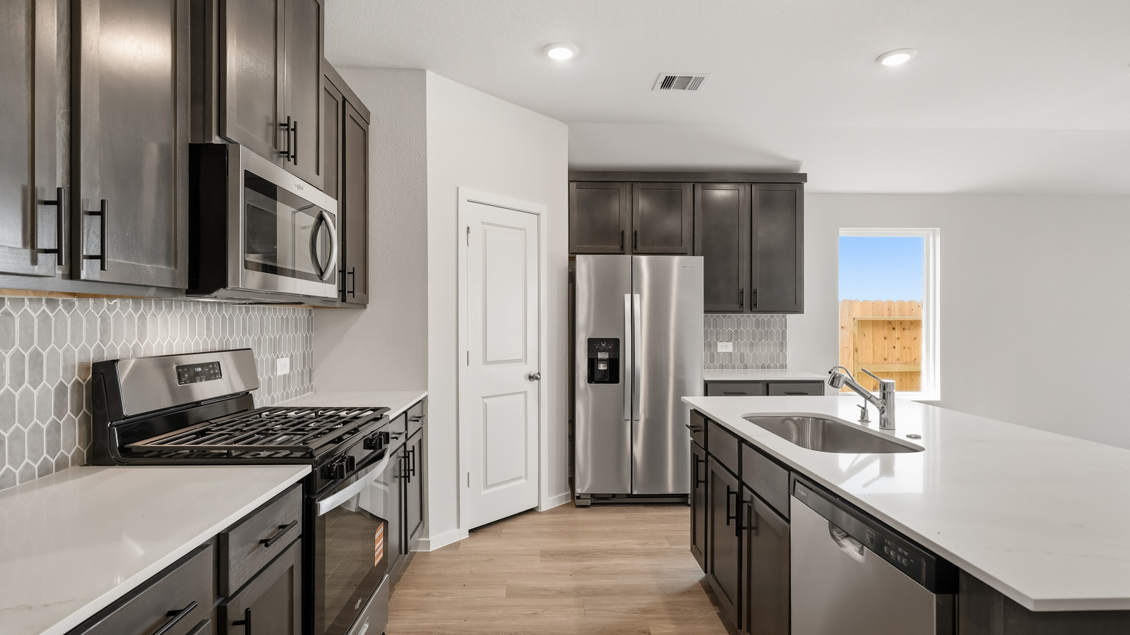 kitchen with quartz countertops, and stainless steel appliances in Brookshire, TX