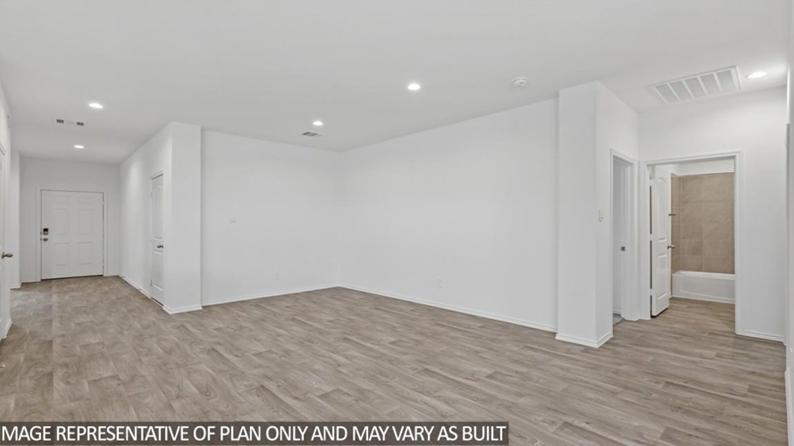 open concept living and dining area with vinyl flooring and large windows in Brookshire, TX