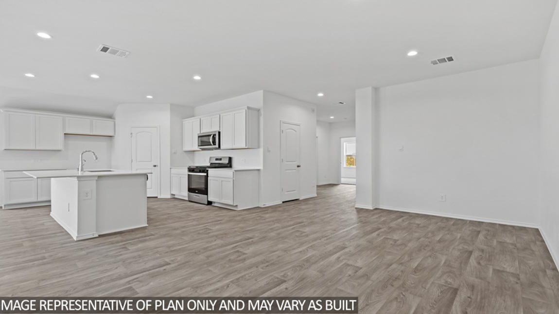 open concept living and dining area with vinyl flooring and large windows in Brookshire, TX