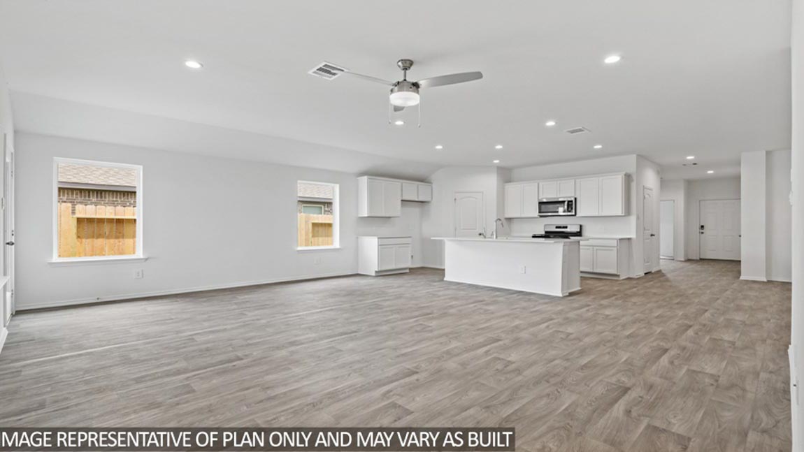 open concept living and dining area with vinyl flooring and large windows in Brookshire, TX