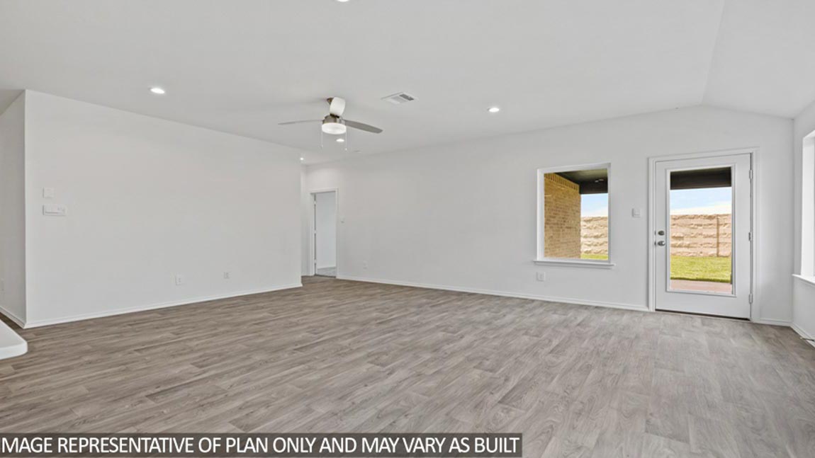 open concept living and dining area with vinyl flooring and large windows in Brookshire, TX