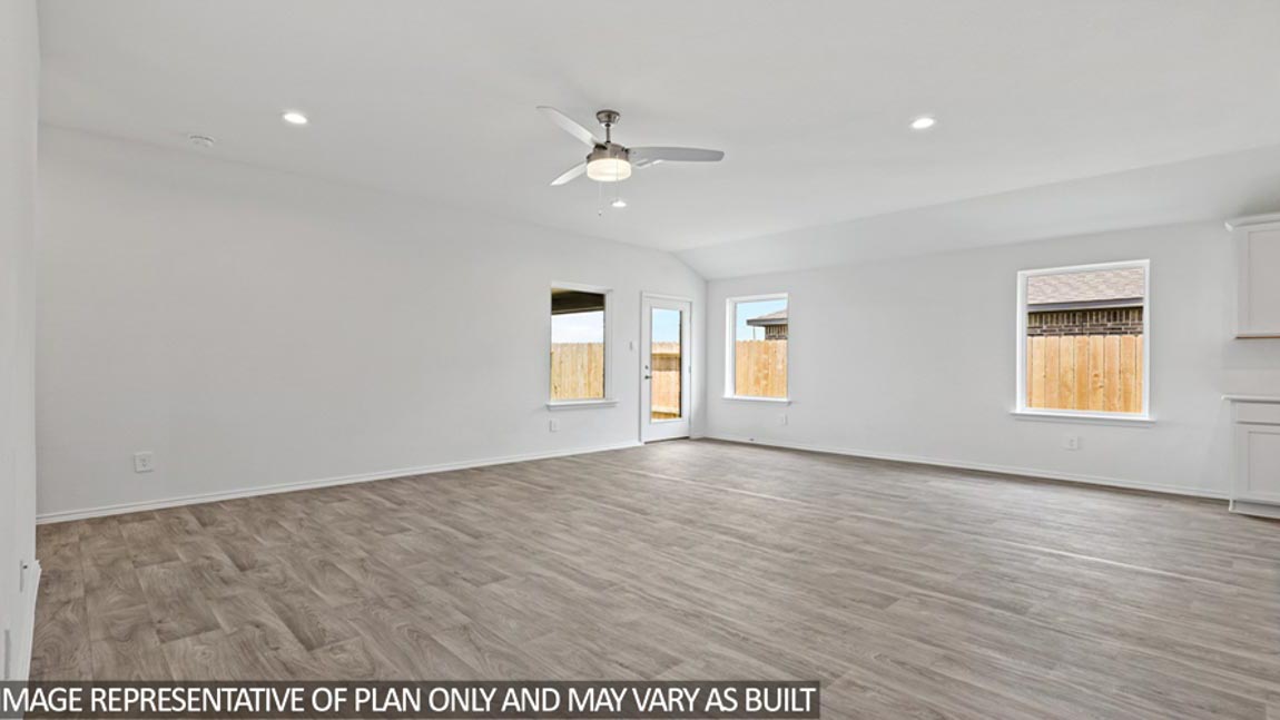 open concept living and dining area with vinyl flooring and large windows in Brookshire, TX