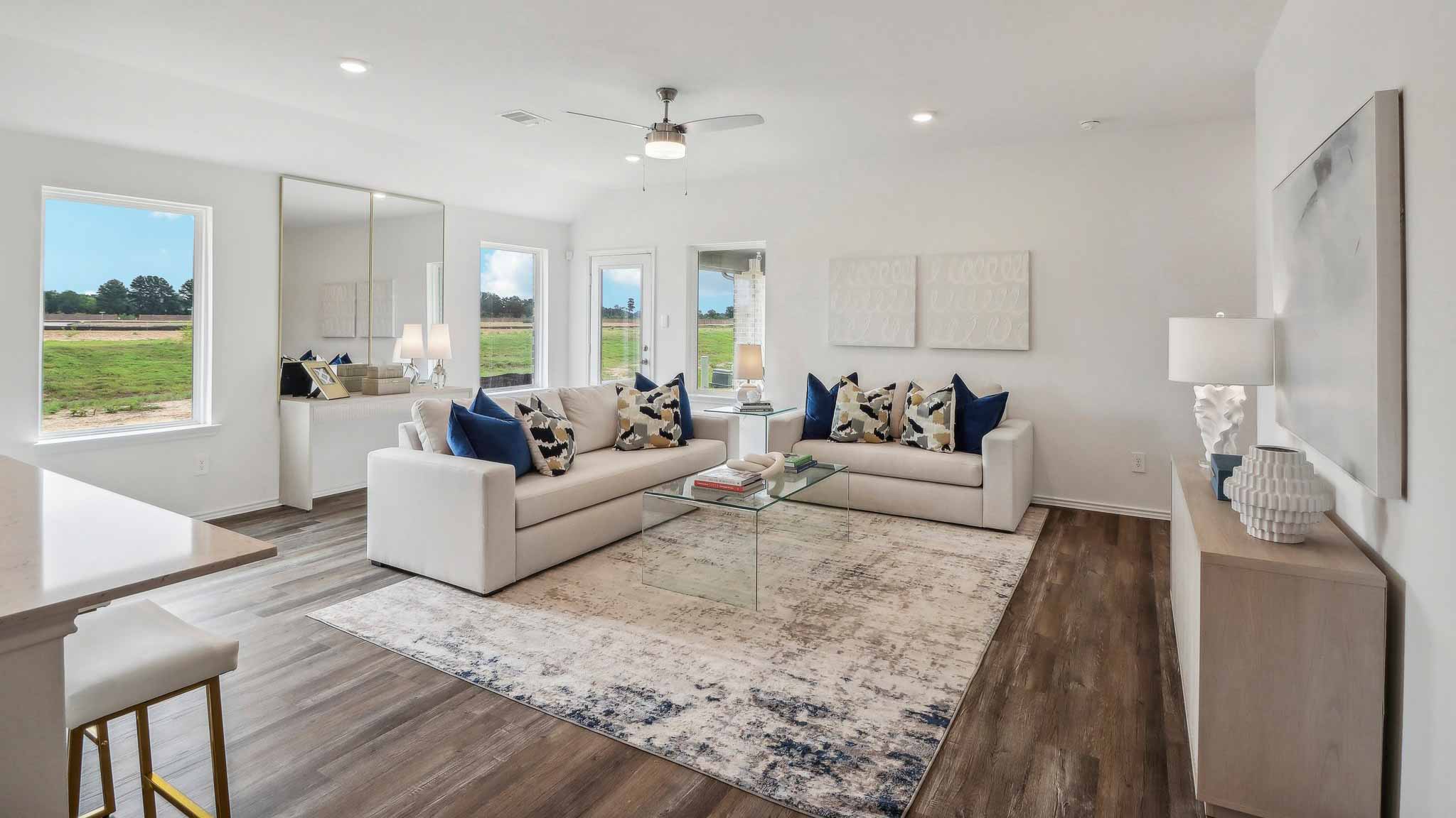 open concept livivng and dining area with vinyl flooring, quartz countertops, and large windows