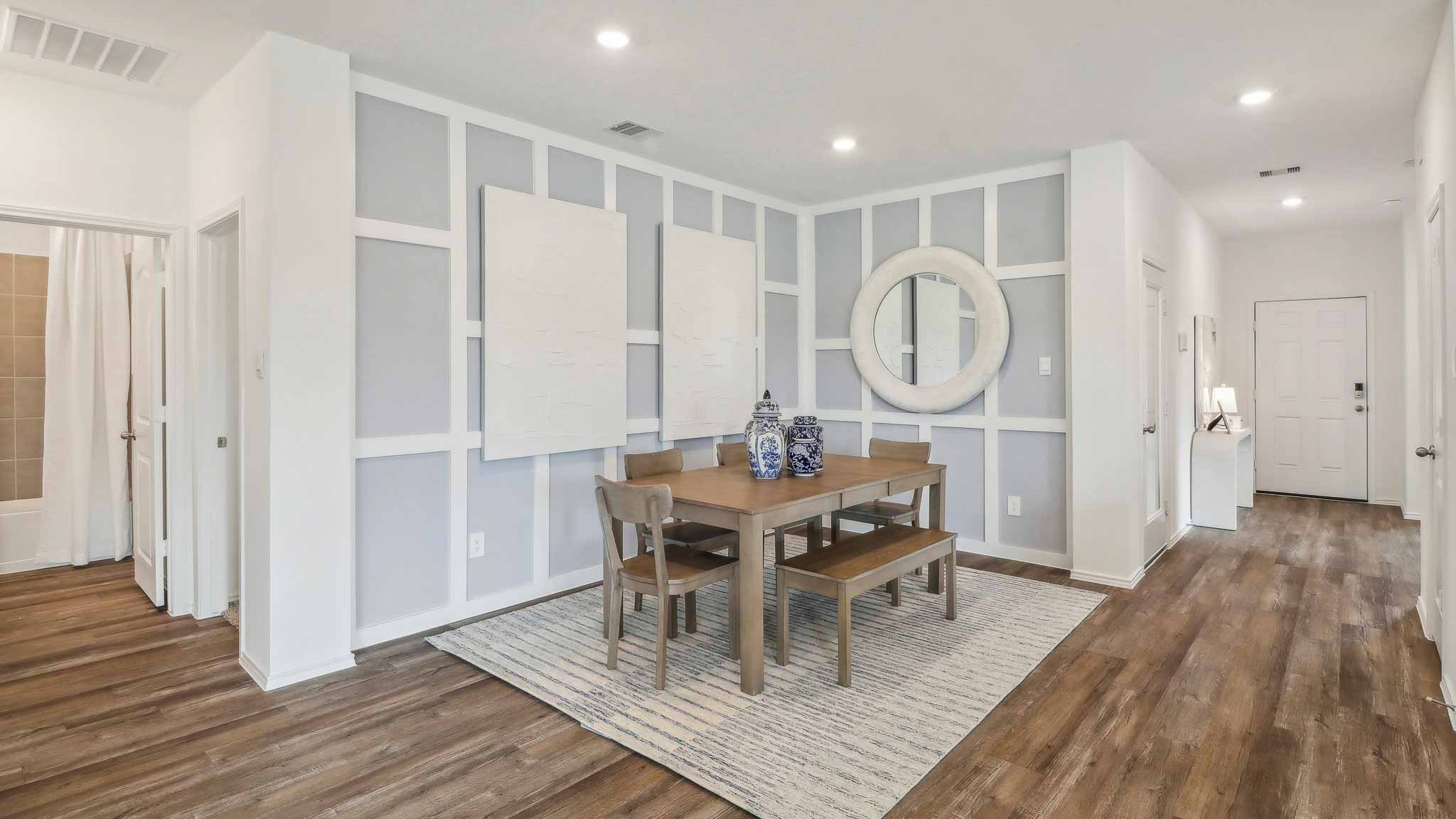 open concept livivng and dining area with vinyl flooring, quartz countertops, and large windows