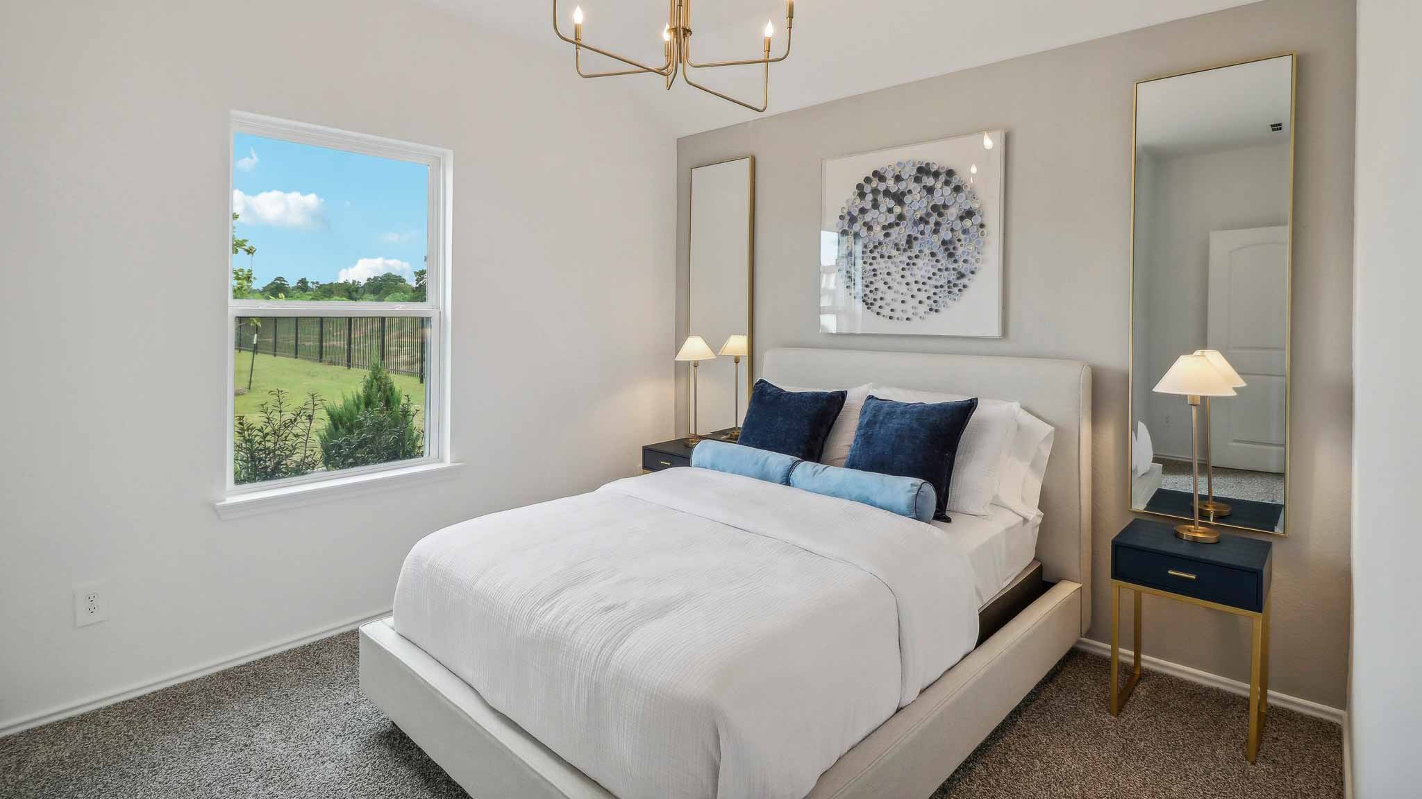 Large Primary bedroom with shag carpet flooring and bright window