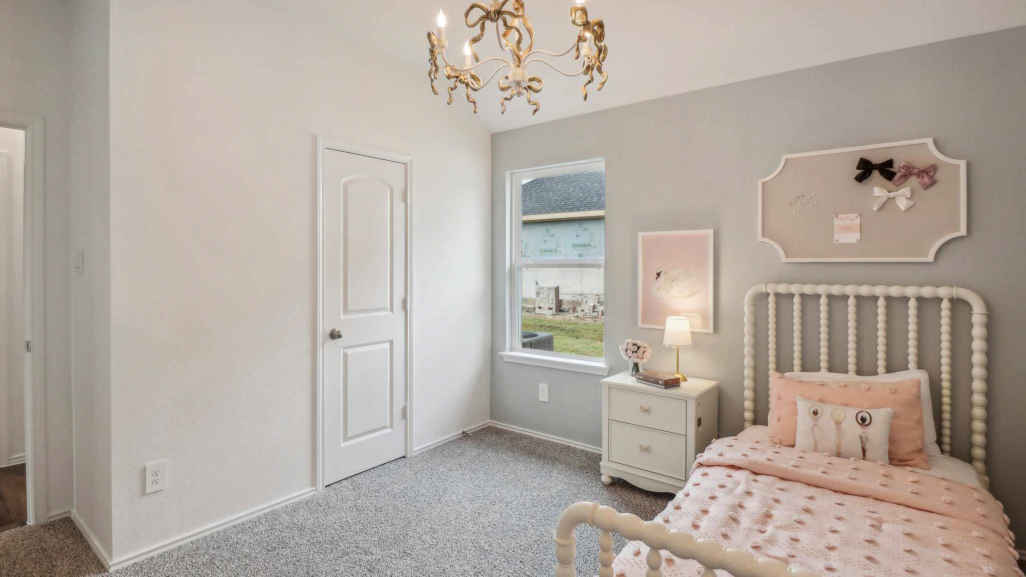 Secondary bedroom with shag carpet flooring and bright window