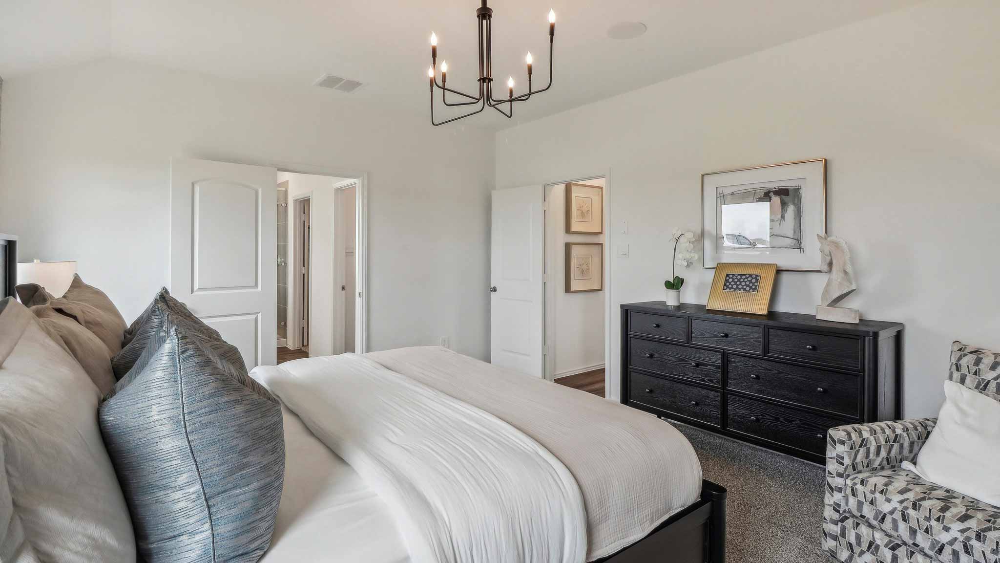 Large Primary bedroom with shag carpet flooring and bright window
