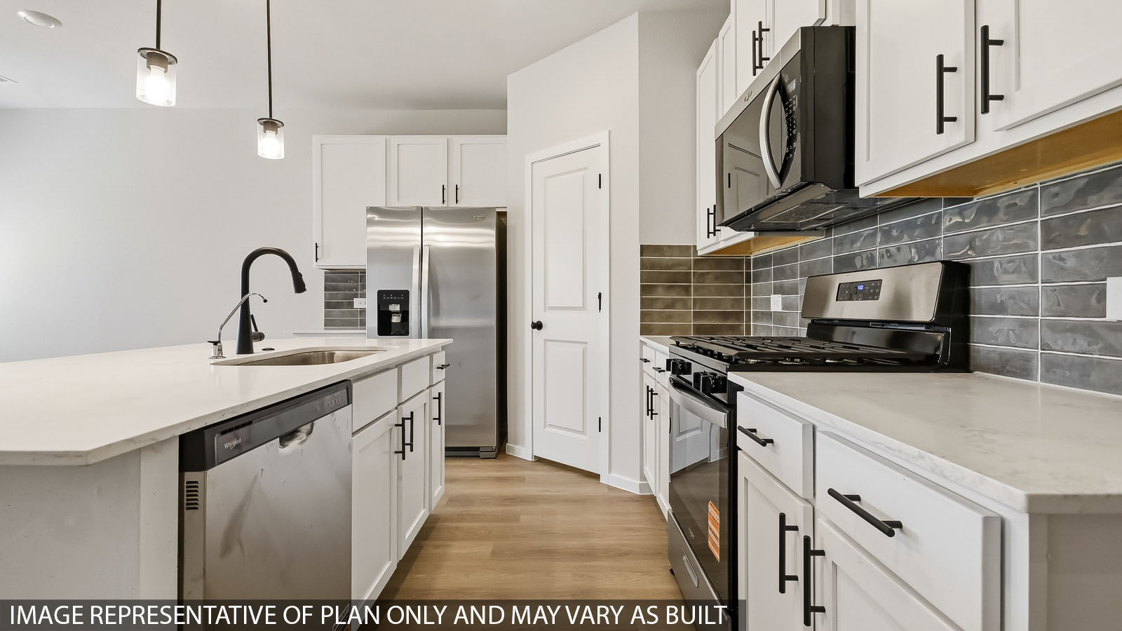 kitchen with stainless steel appliances, quartz countertops, and pendant lights
