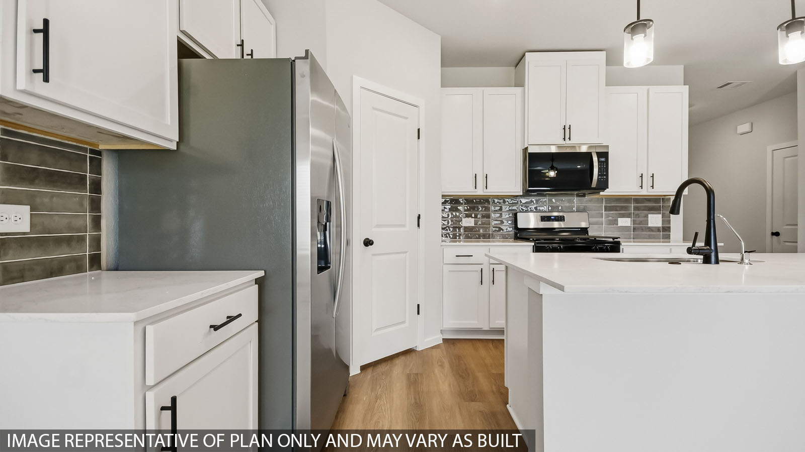 kitchen with stainless steel appliances, quartz countertops, and pendant lights