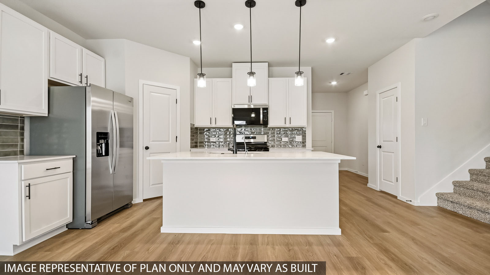 kitchen with stainless steel appliances, quartz countertops, and pendant lights