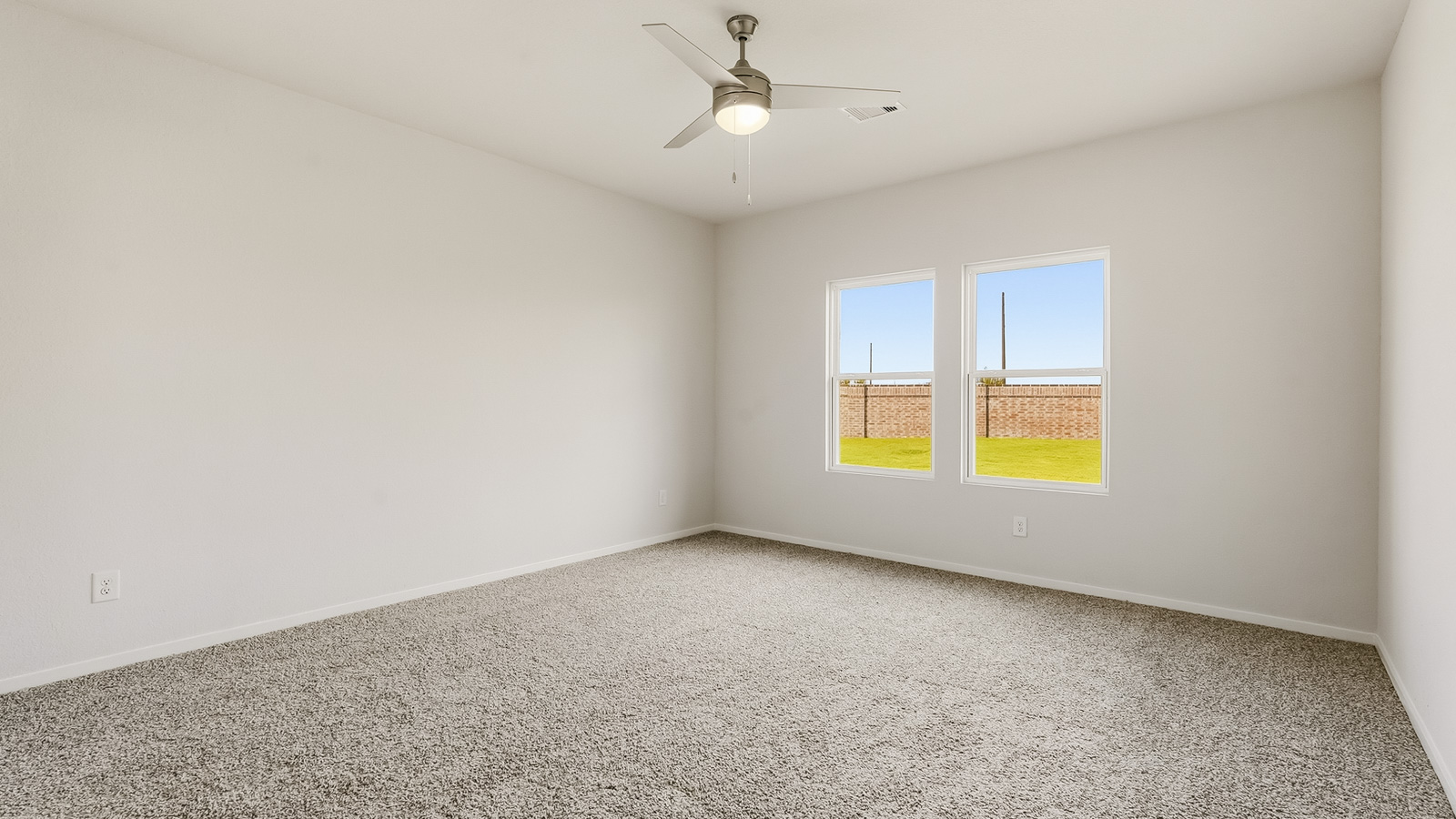 Secondary bedroom with shag carpet flooring and bright window
