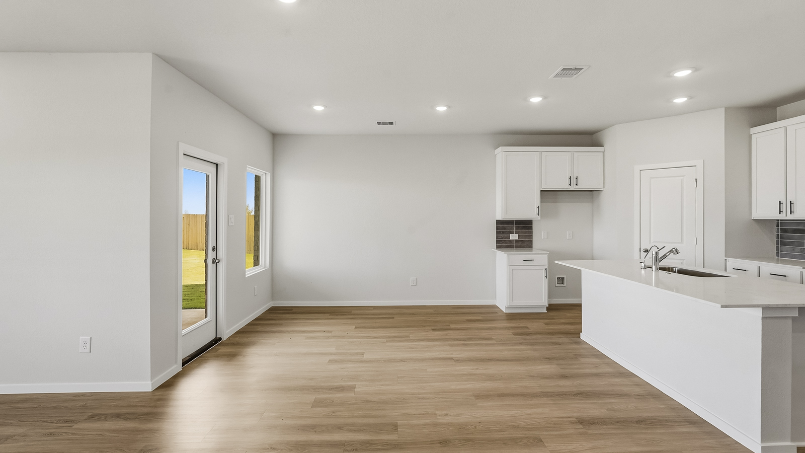 Kitchen with quartz countertops and an island and vinyl floor