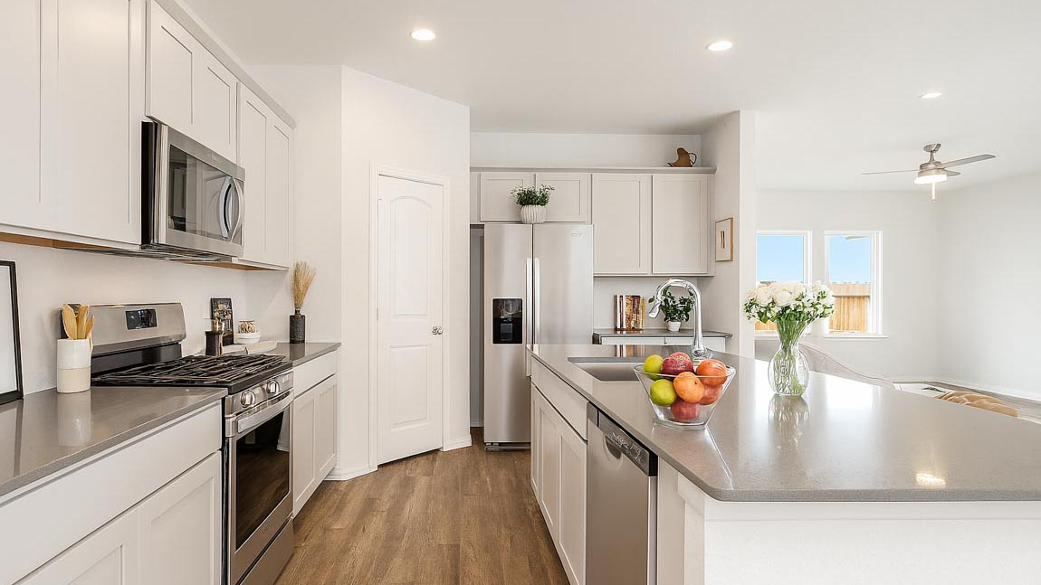 open concept living and dining area with vinyl flooring, quartz countertops, and large windows in Brookshire, Tx