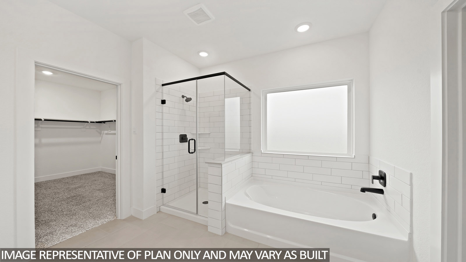 Primary bathroom with soaker tub and tile shower with semi frameless glass in Katy TX