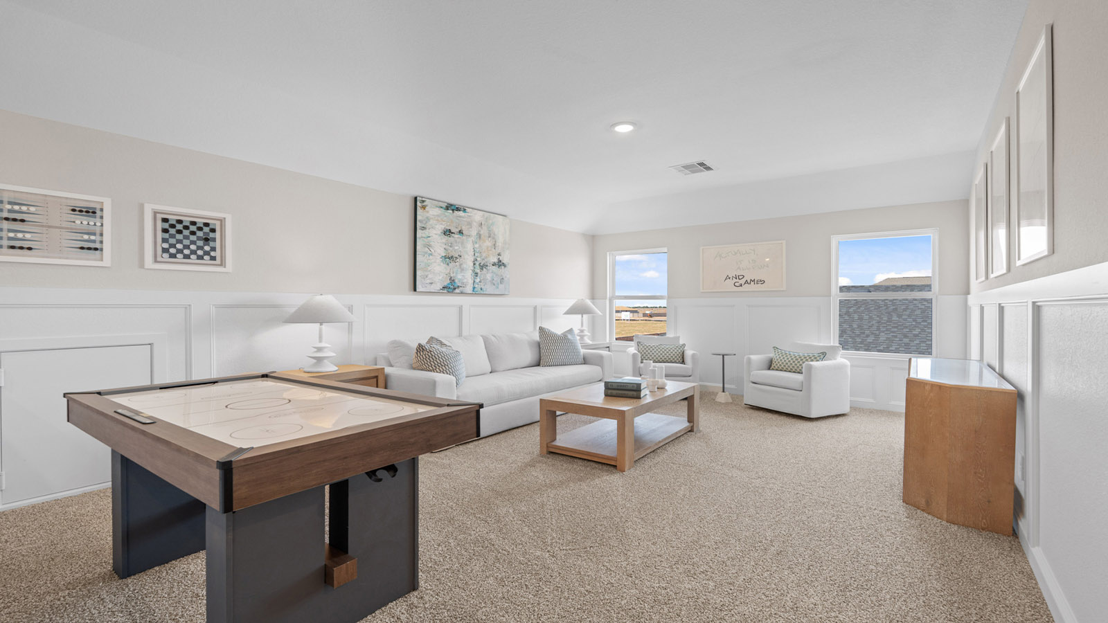 Second story game room with carpet flooring